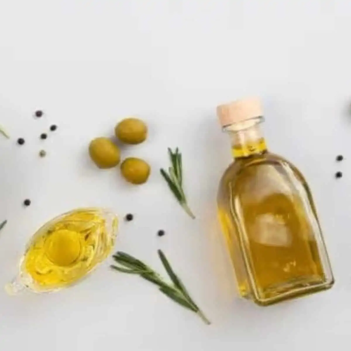 Tasty apple cider vinegar salad dressing ingredients on a white table.