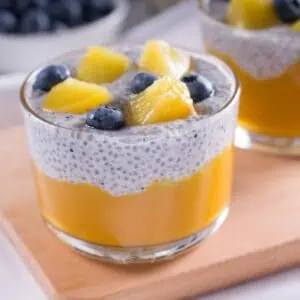 Creamy peach puree chia seed pudding in a glass dish.