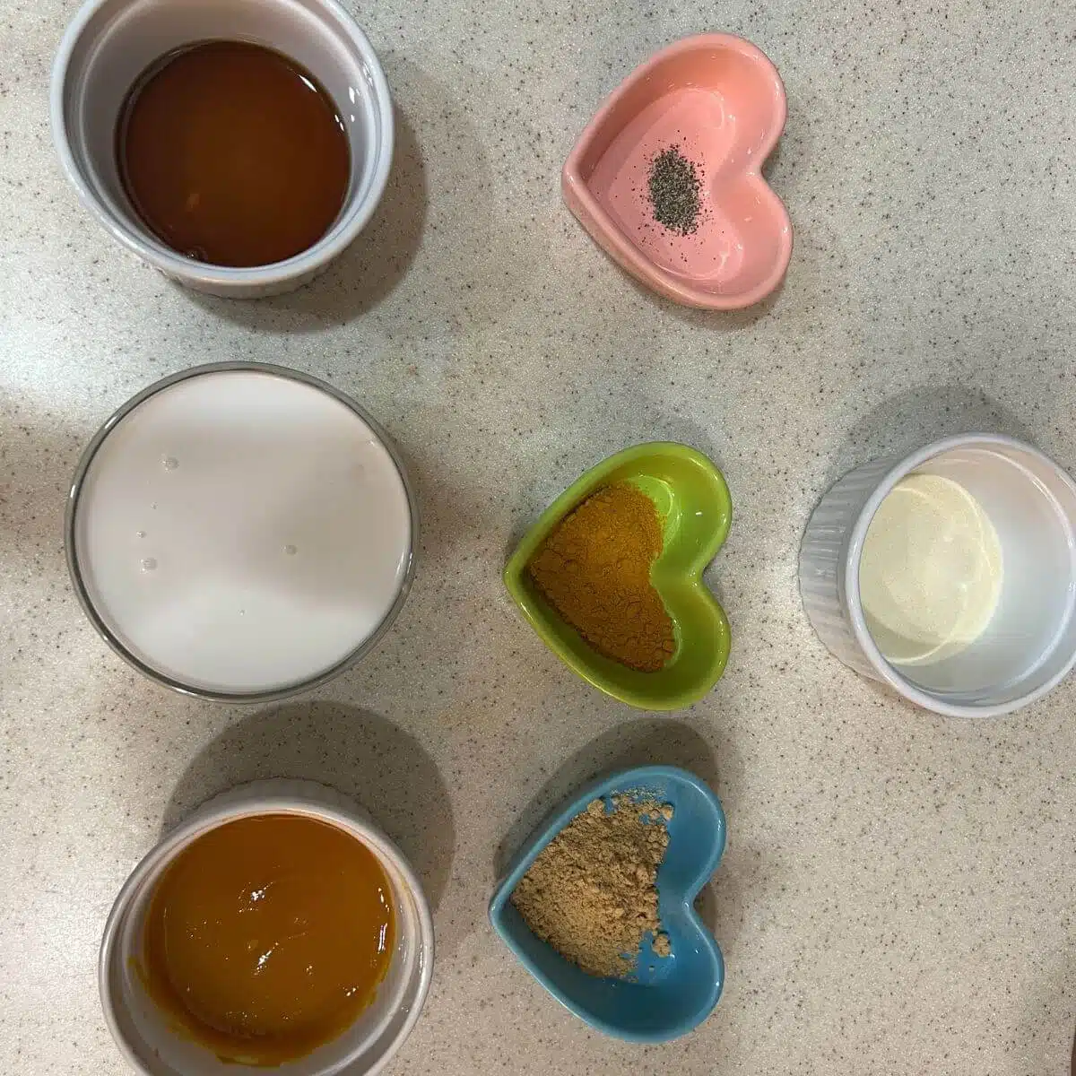 In a small saucepan, combine coconut milk, turmeric, ginger, pumpkin puree, maple syrup, and black pepper.