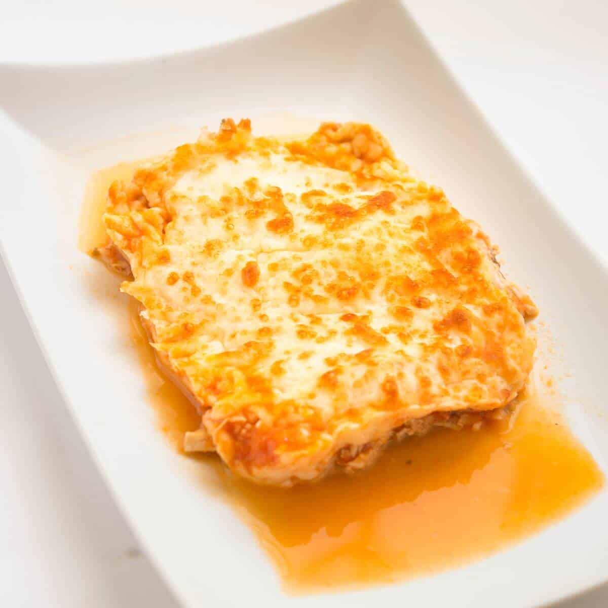 gluten free chicken enchilada on a white plate